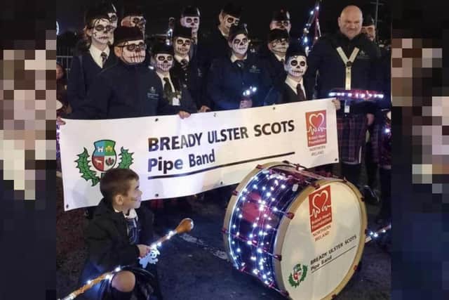 An image of the pipe band and their banned banner, also shared by Gary Middleton