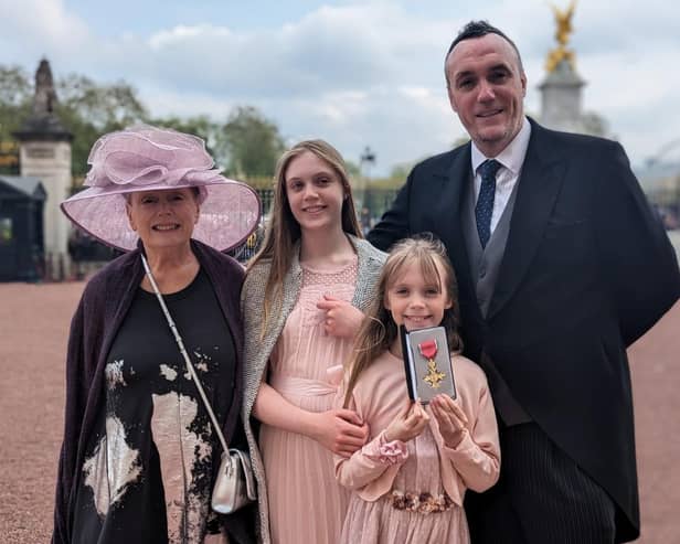Michael Boyd OBE pictured at Buckingham Palace with proud mum Jacqueline Granleese and two daughters Rachel and Olivia