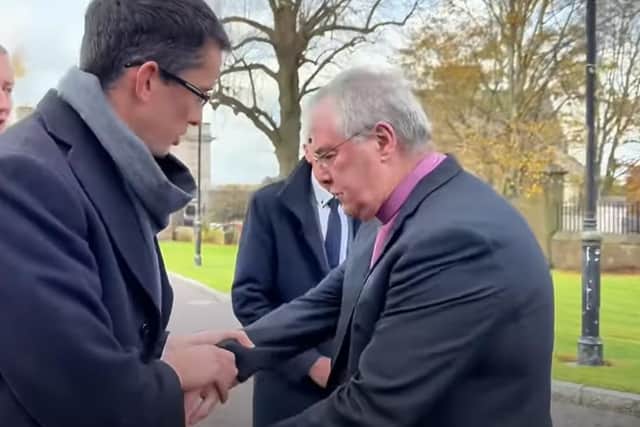 Enoch Burke pictured grabbing the archbishop's arm in another frame of the video
