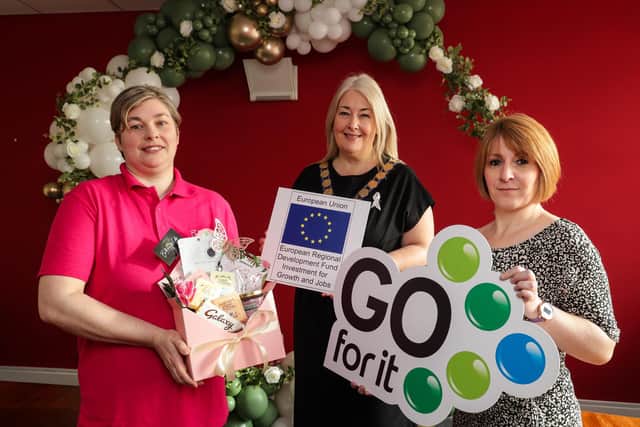A former full-time mum, Erin Brown has turned her childhood passion for balloon modelling into a successful bespoke balloon design business, thanks to the help from the Go For It programme in association with Ards and North Down Borough Council.
Pictured (left to right) is Erin Brown, founder of Balloons and Gifts By Erin, Mayor of Ards and North Down, Councillor Karen Douglas and Emma Pearson, business advisor at North Down Development Organisation.