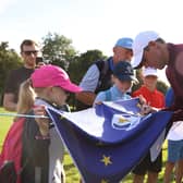 Northern Ireland's Rory McIlroy signing a Ryder Cup Europe flag for young fans earlier this month at the Horizon Irish Open. (Photo by Oisin Keniry/Getty Images)