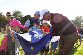 Northern Ireland's Rory McIlroy signing a Ryder Cup Europe flag for young fans earlier this month at the Horizon Irish Open. (Photo by Oisin Keniry/Getty Images)