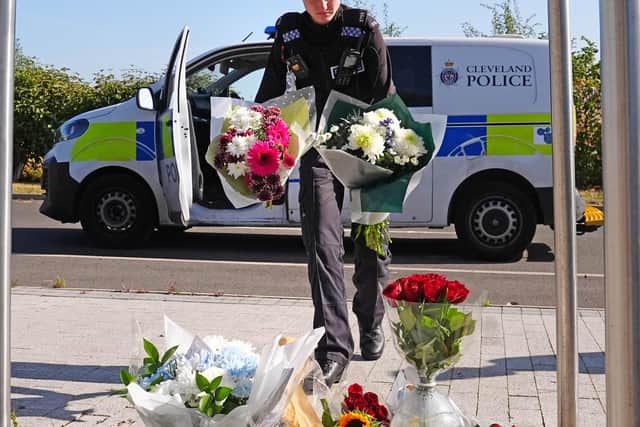 A police officer leaves flowers at the Cleveland Police HQ Memorial Garden in Middlesbrough, following the line-of-duty deaths of PC Matthew Blades and PC Tom Clough were killed when a Volkswagen Passat – which had been pursued by police – was driven the wrong way along a dual carriageway and hit their marked armed response vehicle. Picture date: Monday August 24, 2026.