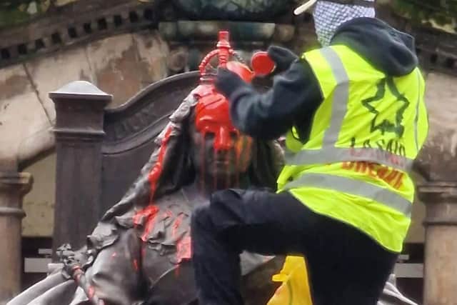 A member of republican group Lasair Dhearg this afternoon tipped paint over a statue of Queen Victoria in the grounds of west Belfast's Royal Victoria Hospital. Photo: Lasair Dhearg/Facebook