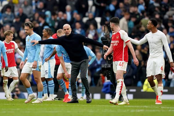 Manchester City manager Pep Guardiola speaks with Arsenal's Gabriel (right) following the 0-0 Premier League stalemate at the Etihad Stadium
