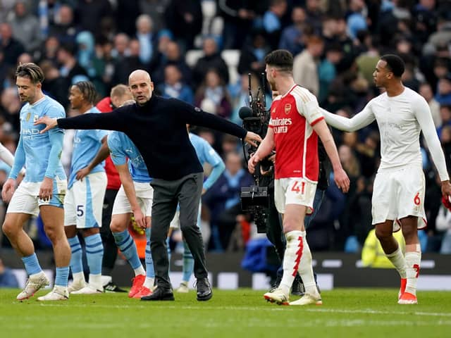 Manchester City manager Pep Guardiola speaks with Arsenal's Gabriel (right) following the 0-0 Premier League stalemate at the Etihad Stadium