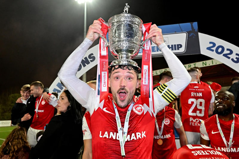 Larne captain Tomas Cosgrove celebrates with the Premiership title