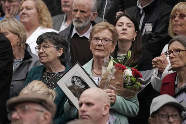 People attend a wreath-laying ceremony at the Memorial to the victims of the Dublin and Monaghan bombings on Talbot Street in Dublin