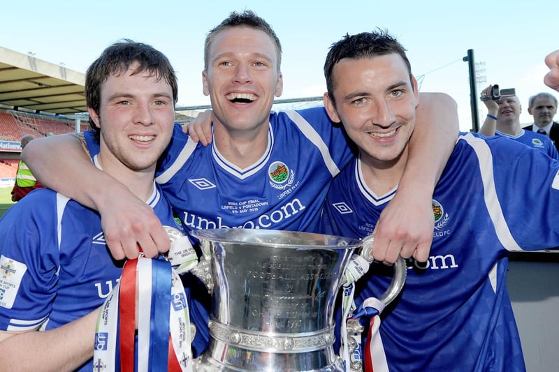 Linfield's Jamie Mulgrew, Peter Thompson and Michael Gault celebrate with the trophy