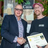 Newtownards-based Farmhouse Cheesemaker, Mike Thomson of Mike’s Fancy Cheese, being presented with the gold award in the ‘Blue Cheese’ category at the 2024 Irish Cheese Awards by broadcaster and MC for the event, Bobby Kerr