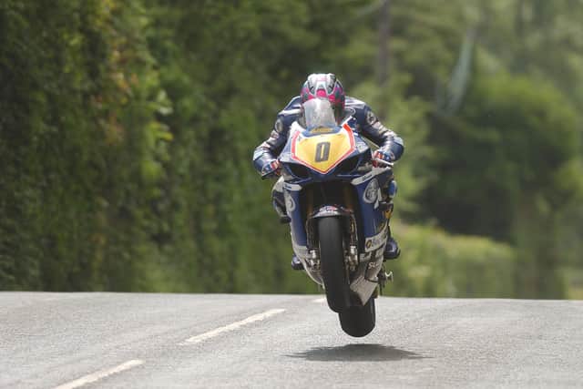 Adrian Archibald (TAS Suzuki) at Ballacrye on his way to victory in the Senior race  at the Isle of Man TT in 2003.