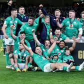 Ireland's players celebrate with the trophy after winning the Six Nations Grand Slam at the Aviva Stadium in Dublin on Saturday after beating England.