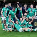 Ireland's players celebrate with the trophy after winning the Six Nations Grand Slam at the Aviva Stadium in Dublin on Saturday after beating England.