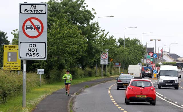 Cars cross the border between Northern Ireland and Ireland, near Londonderry