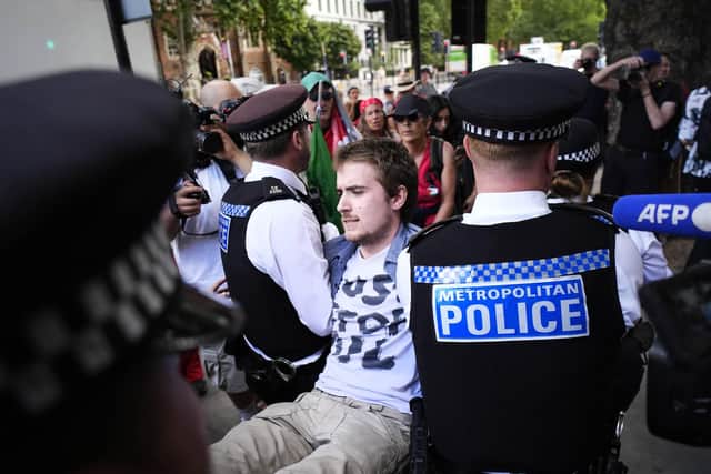 A person is removed by police as Palestine Action and Defend Our Juries protest outside Westminster Magistrates' Court, London, where Jeremy Shippam, Judit Murray and Fiona Maclean and 25 others are charged with with showing support for Palestine Action. Picture date: Thursday July 30, 2026.