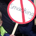 A young child holding an anti-smacking placard on a march to Downing Street, London in 2004. Photo: Rebecca Naden/PA Wire