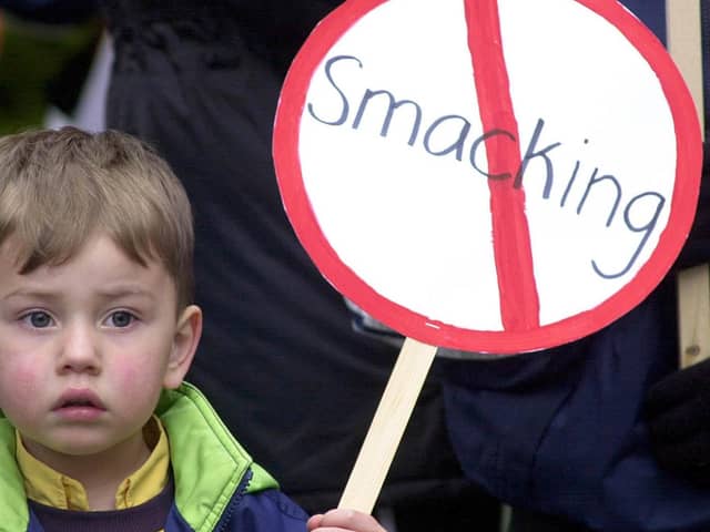 A young child holding an anti-smacking placard on a march to Downing Street, London in 2004. Photo: Rebecca Naden/PA Wire
