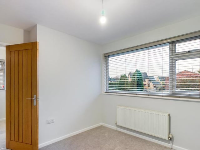 All three bedrooms are extremely well finished and presented. This one faces the back of the property, while the third features a handy over-stairs storage cupboard.