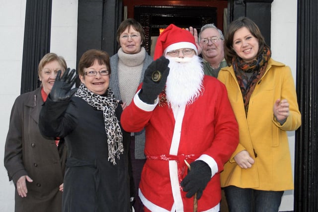 Members of Marie Curie including Stanley Jamieson, Margaret Delargy, Fiona Jamieson, Catherine McCambridge and Helen McCambridge, chair of the Moyle and District Support Group, with Santa Claus at the annual coffee morning and cake sale in The Antrim Arms.INBM49-10 232JC
