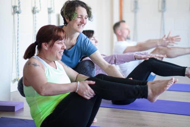 Practising boat pose with instructor Claire Ferry