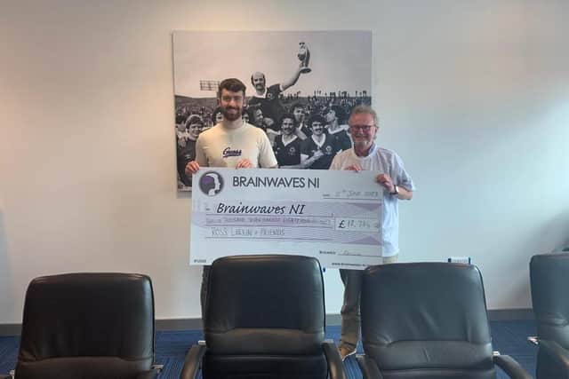Ross Larkin presents a cheque worth £12,784 to Brainwaves NI after a fundraising campaign which also saw him complete the Belfast Marathon