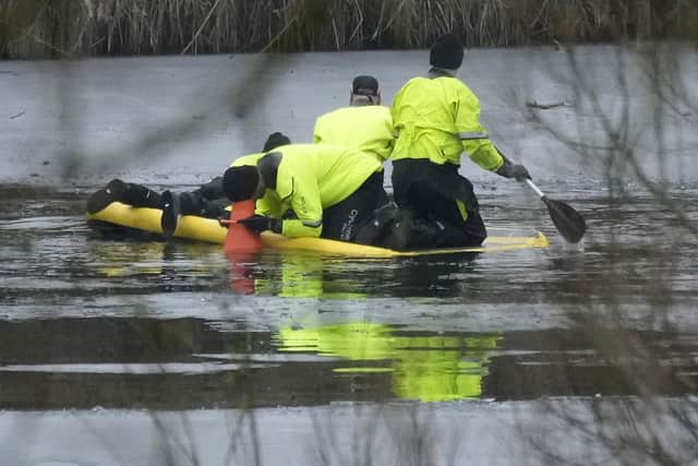SOLIHULL, ENGLAND - DECEMBER 12: Emergency workers continue the search for further victims after a number of children fell through ice on a lake,  on December 12, 2022 at Babbs Mill Park in Solihull, England. Three boys aged eight, 10 and 11 have died after falling through an icy lake here last night. The search continued for more potential victims, following reports more children were present on the ice at the time of the incident. (Photo by Christopher Furlong/Getty Images)