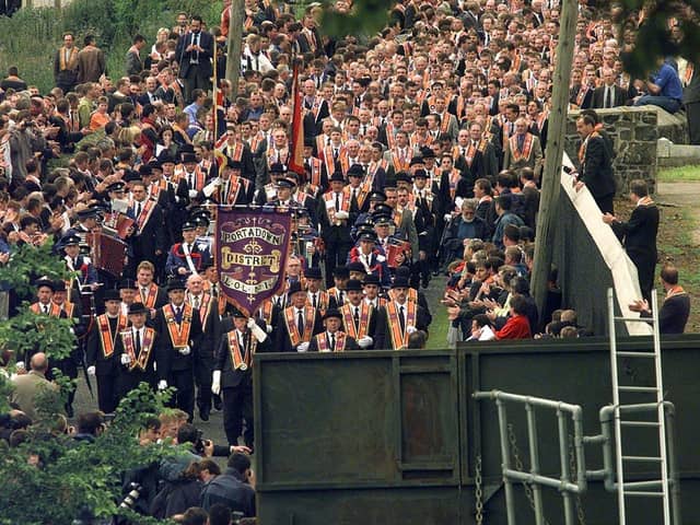 Members of the Orange Order from marching from Drumcree Church towards the barricade blocking their route along the nationalist Garvaghy Road on July 5 1998. Days later three boys would be burned to death in Ballymoney by a petrol bomb thrown through into their house by loyalists