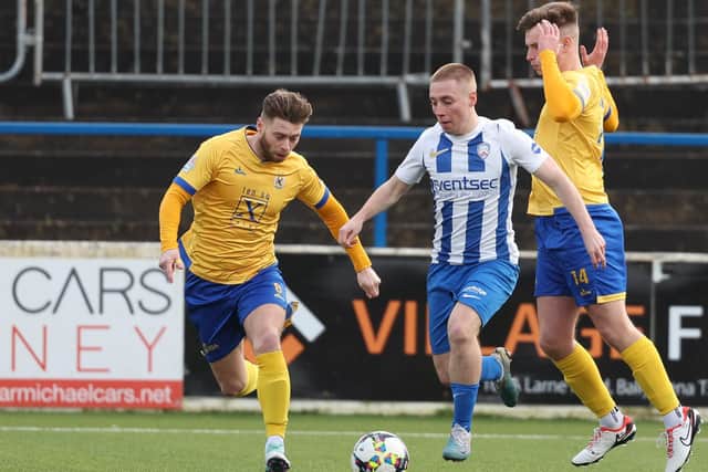Coleraine winger Conor McKendry is paid close attention by James Knowles and Adam Glenny at The Showgrounds