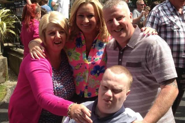 Jo-Anne Dobson (centre) has paid tribute to "devoted" Portadown couple Mark and Carol McClory (left and right) after Mark donated a kidney to their son, Scott (seated).