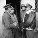 General Sir Harold Alexander (right), commanding the 15th Army Group, talks to British and American officers at Anzio, Italy, in February 1944
