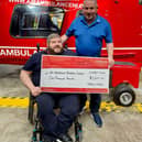 Tim Webb and his dad Ivan present a cheque of £1,000 to the Air Ambulance following his 'Webbers Wheels' event