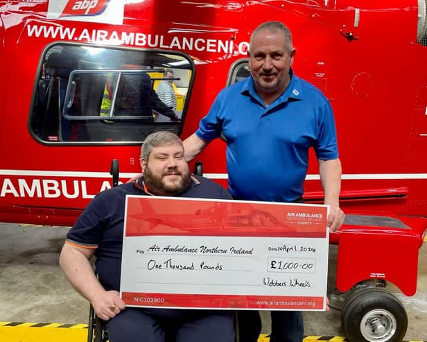 Tim Webb and his dad Ivan present a cheque of £1,000 to the Air Ambulance following his 'Webbers Wheels' event
