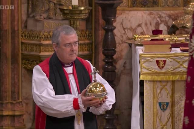 The Anglican Archbishop of Armagh and Primate of All Ireland John McDowell brings the Orb to the king from the altar at the coronation of King Charles. May 6 2023. Screengrab from BBC