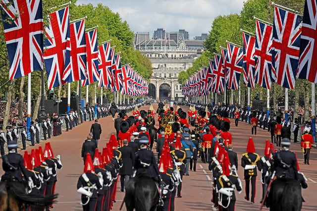 The coffin of Queen Elizabeth II, adorned with a Royal Standard and the Imperial State Crown is pulled by a Gun Carriage of The King's Troop Royal Horse Artillery, during a procession from Buckingham Palace to Westminster Hall on September 14, 2022.