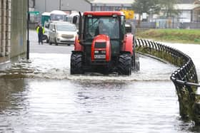 A tractor makes its way through flood water in Canal Quay in Newry Town, Co Down, which has been swamped by floodwater as the city's canal burst its banks amid heavy rainfall: Wednesday November 1, 2023