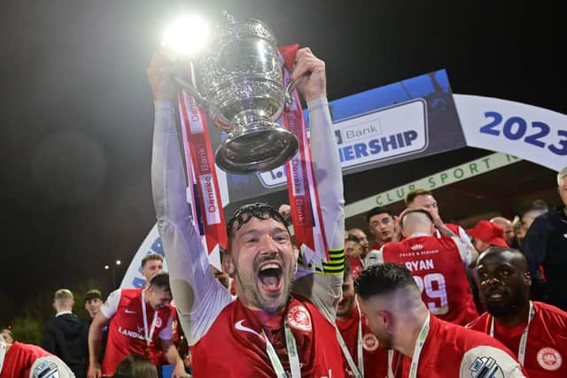 Larne captain Tomas Cosgrove celebrates lifting the Gibson Cup trophy. PIC: Colm Lenaghan