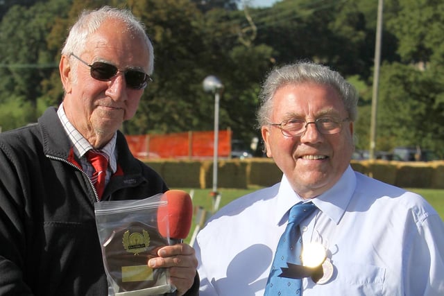 Norman Taylor receives an award in 2010 from Longnor Sports' Roy Mellor in recognition of his long service.
