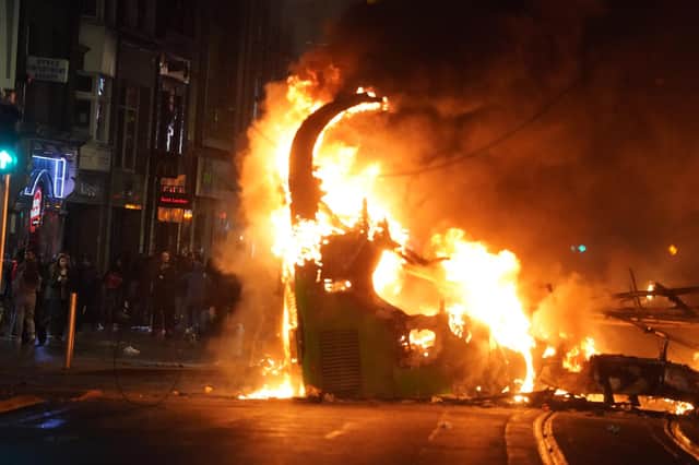 A bus on fire on O'Connell Street in Dublin city centre after violent scenes unfolded following an attack on Parnell Square East where five people were injured, including three young children. Photo: Brian Lawless/PA Wire