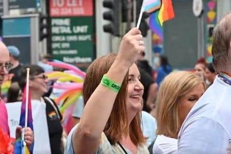 Head of the NI Civil Service Jayne Brady waving a 'progress' flag - a contested symbol of the LGBTQ+ movement - at Belfast Pride.
