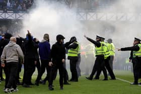 ​Police and stewards force fans back after Sunday's Ibrox pitch invasion following the Scottish Cup quarter-final between Rangers and Celtic. (Photo by Steve Welsh/PA Wire)