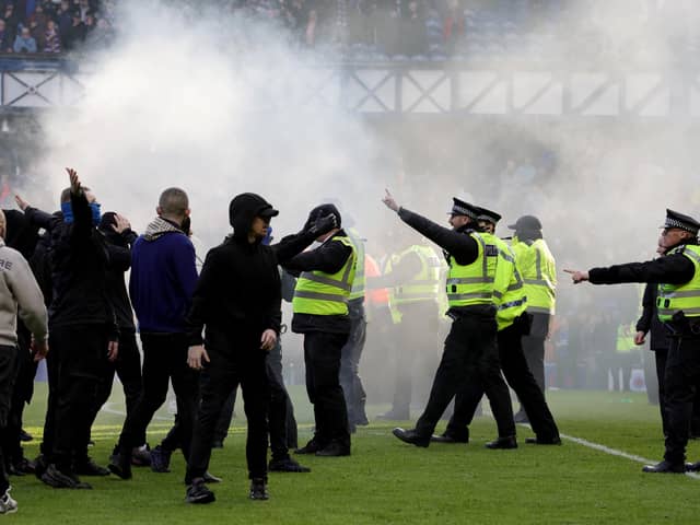 ​Police and stewards force fans back after Sunday's Ibrox pitch invasion following the Scottish Cup quarter-final between Rangers and Celtic. (Photo by Steve Welsh/PA Wire)