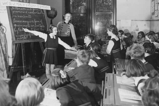 Children at Cheadle high school are encouraged to listen to the news and read the papers. Once a week, the teacher will give a talk on current events which is followed by the pupils own opinions. Seven year old Jacqueline Loman addresses the class on Hitlerism and democracy.   (Photo by Fox Photos/Getty Images)