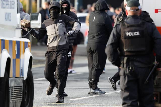 PSNI officers face protestors on the York Road in North Belfast