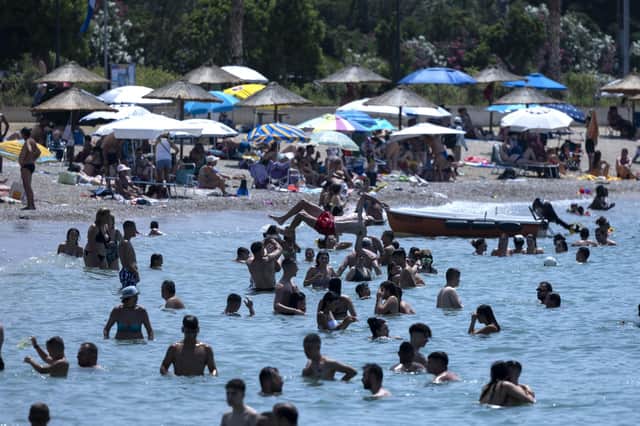 Swimmers enjoy the sea at Glyfada suburb, in Athens, Greece, Saturday. Temperatures reached up to 42 degrees Celsius in some parts of the country, amid a heat wave that continues to grip southern Europe. (AP Photo/Yorgos Karahalis)