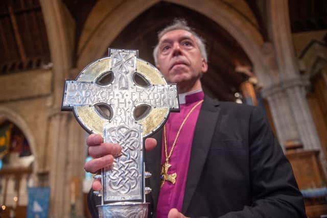 Archbishop of Wales Andrew John with The Cross of Wales ahead of a blessing service at Holy Trinity Church in Llandudno, north Wales. The new processional cross was presented by King Charles III as a centenary gift to the Church in Wales, and will lead the coronation procession at Westminster Abbey on May 6.