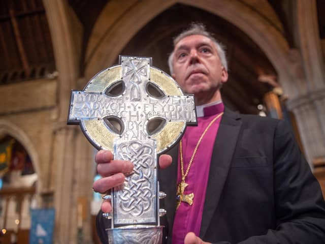 Archbishop of Wales Andrew John with The Cross of Wales ahead of a blessing service at Holy Trinity Church in Llandudno, north Wales. The new processional cross was presented by King Charles III as a centenary gift to the Church in Wales, and will lead the coronation procession at Westminster Abbey on May 6.