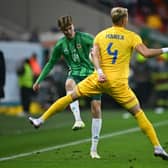 Northern Ireland's Isaac Price challenges for the ball with Romania's Cristian Manea during the friendly match last Friday