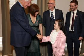 Bill Clinton shakes hands with Lyra McKee’s great-niece Ava Corner, eight, at the launch of the documentary film ‘Lyra’ at Queen’s Film Theatre in Belfast
