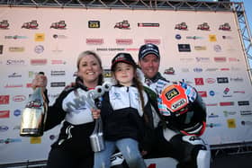 Alastair Seeley celebrates his victory in the opening Superstock race at the 2023 North West 200 with wife Danni and daughter Olivia-Grace