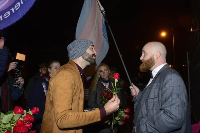 Matthew Grech offers a protestor a rose at the showing of a film about his life in Belfast in 2019. LGBT protestors picketed the film.
Picture By: Arthur Allison.